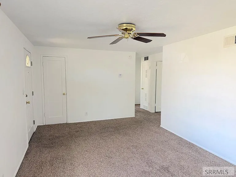 Living room with neutral walls and carpet