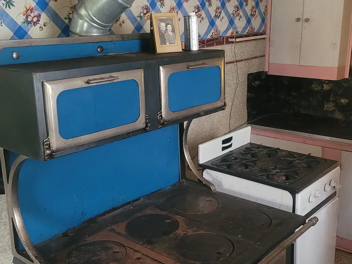 Traditional wood cook stove and propane stove in the galley kitchen