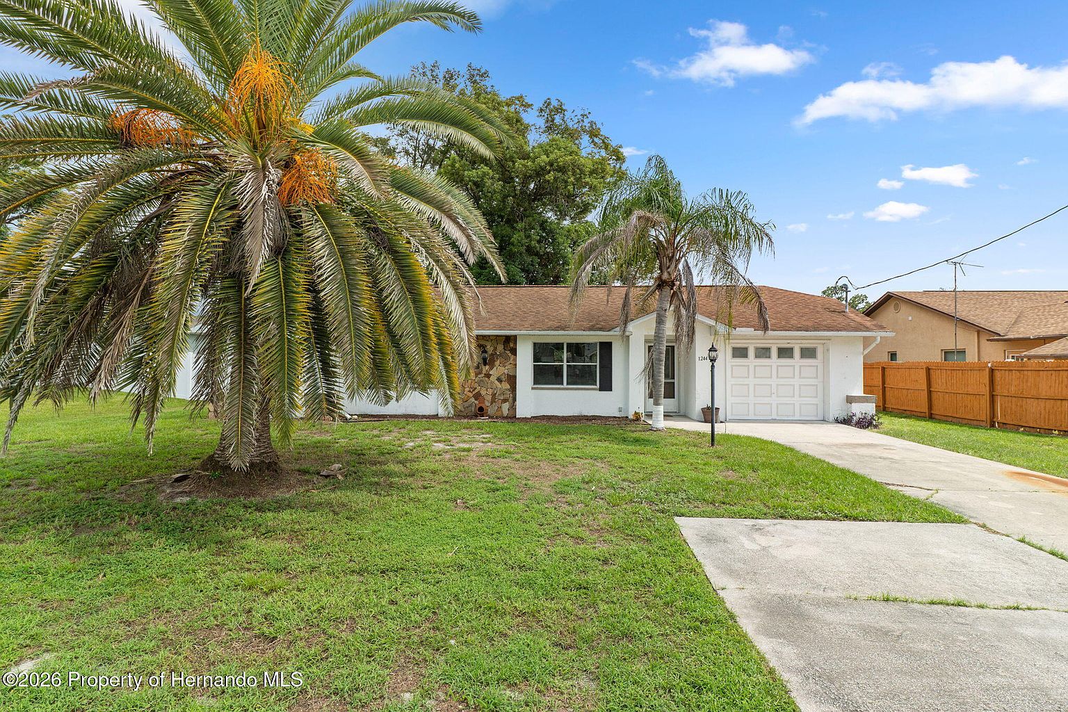 Front exterior of the Spring Hill home with attached garage