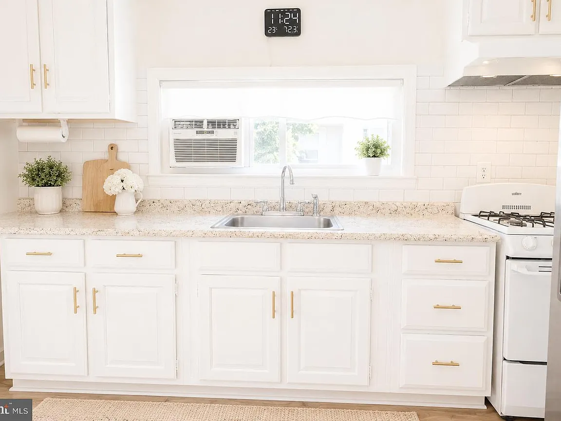 White galley kitchen with appliances and storage