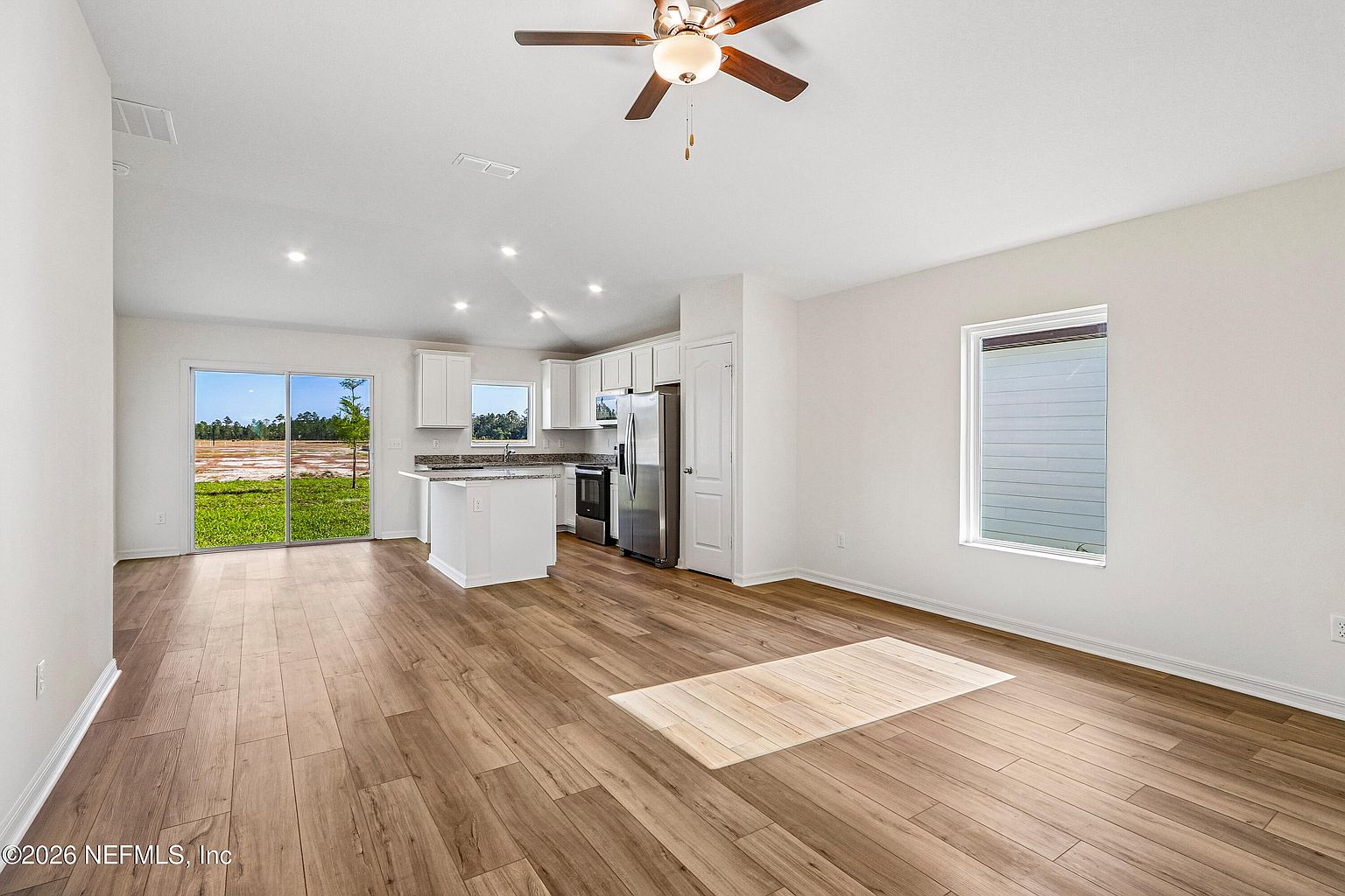 Open living and dining area leading into the kitchen