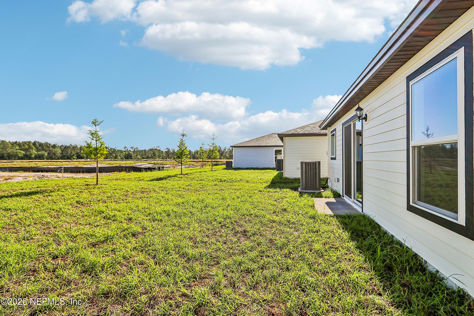 Grassy backyard behind the Jacksonville home