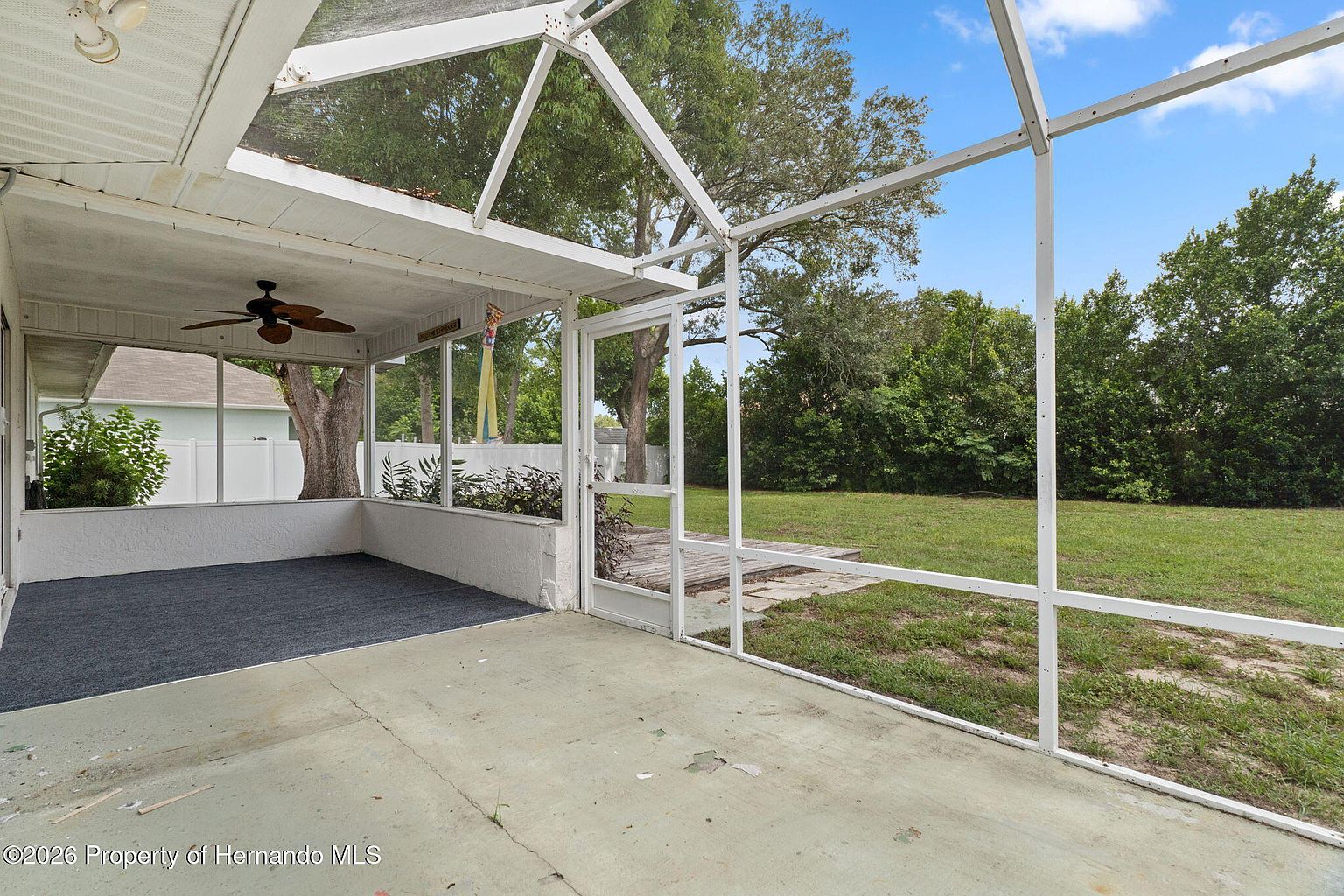 Large screened porch overlooking the fenced backyard