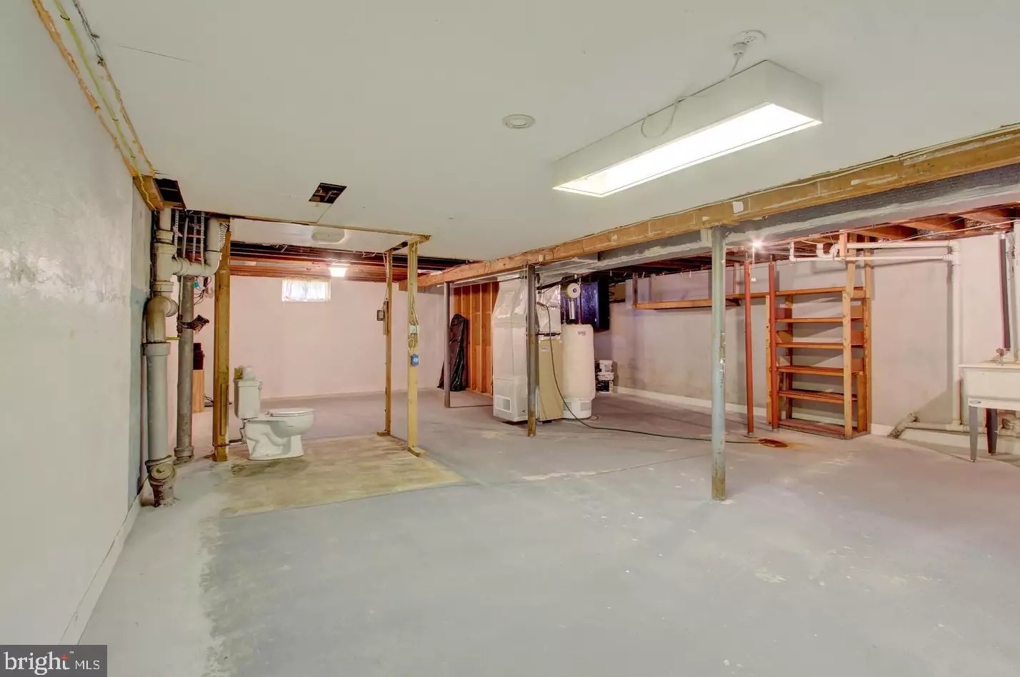 Unfinished basement with exposed storage area